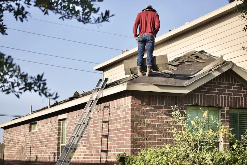 Professional roofer working on a residential roof in North Cambridge